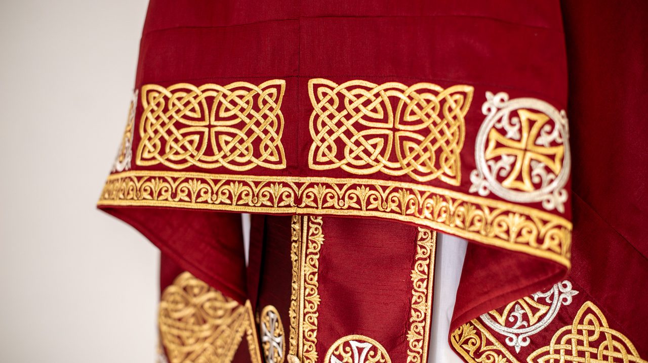 Embroidered red and gold Orthodox phelonion with knotwork and crosses