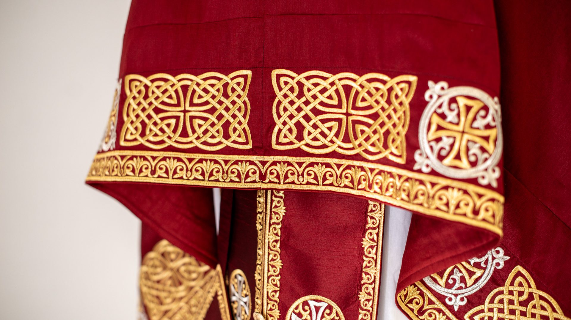 Hand-embroidered red and gold Orthodox phelonion with knotwork and crosses